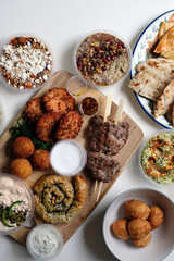 Middle Eastern feast delivery at home with fresh bread, meats, dips and croquets