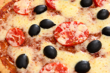 homemade pizza, vegetarian food, baked vegetables and cheese, tomatoes and olives, delicious food on a wooden background