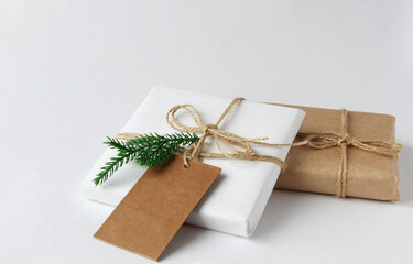 Christmas gifts on a light background in a light package. Copy space. 