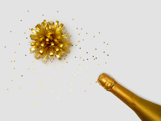 Champagne bottle with gold confetti stars on a light background. The concept of Christmas, birthday or wedding