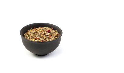 A set of condiments for cooking in a brown Cup on a white background. Side view with copy space, panorama.