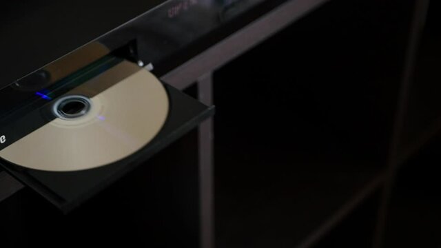 Blu-ray Disc, Shot Eject From Blu-ray Disc Player. Unloading Compact Disc From The DVD/CD Player.