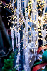 Outdoor Icicles Christmas Decoration and light garlands, blurred background