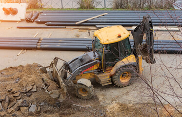 yellow tractor, bulldozer works on the construction site. Top view, horizontal photo.