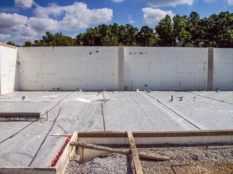 Construction site for a berm home with forms in place for pouring the concrete floor