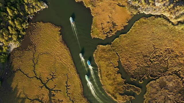 Scenic above view of moving boats in Dalyan river among rare landscape shapes