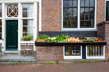 Fototapeta na wymiar Fresh fruit display outside a shop Amsterdam, house facade