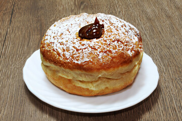 Hanukkah Sufganiyah - Jewish Donut for Jewish holiday Hanukkah.  Sufganiyah - symbol of Hanukkah. Hebrew name Sufganiyah -  Sufganiot. Israeli and Jewish cuisine, Israel