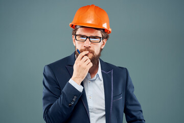 A man wearing an orange hard hat industry official job