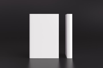 Two hardcover vertical white mockup books standing on the black background. Blank front cover and spine of book.