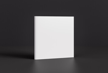 Hardcover square white mockup book standing on the black background.