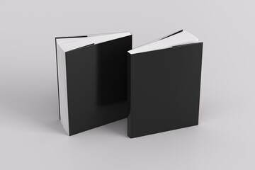 Two softcover or paperback vertical black mockup books standing on the white background. Blank front and back cover.
