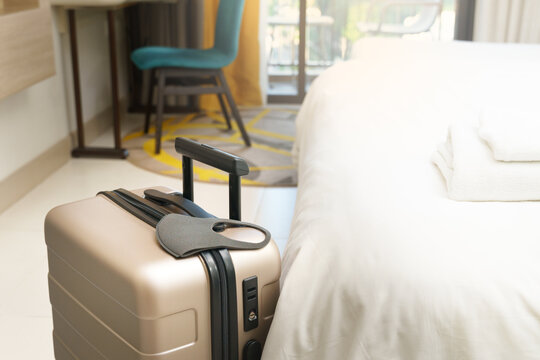 Stay safe while travel during Covid 19 pandemic concept. A suitcase or baggage with a medical face mask in the hotel room. Travel bubbles, Business trip, ASQ Alternative state quarantine, New normal.