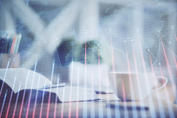 Multi exposure of forex graph drawing and desktop with coffee and items on table background. Concept of financial market trading