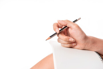 Close up of hand holding pencil with notebook isolate on white background.