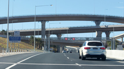Naklejka premium New westconnex motorway and over passes. A white car travelling on the road. 80km speed limit signs. Sydney, Australia
