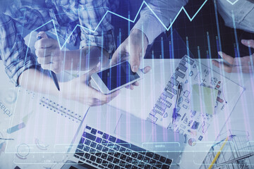 Double exposure of forex graph drawing and man and woman working together holding and using a mobile device. Trade concept.