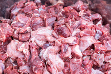 Close-up on chunks of raw beef. Barf raw meat diet preparation for dogs