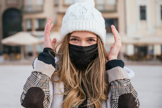 Portrait Of A Beautiful Young Woman Wearing Face Mask And Winter Clothes