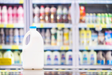 Advertise, Drink milk for healthy concept - Milk bottle in a supermarket on background blurred beverage, milk showing on shelves in the cold freezer.