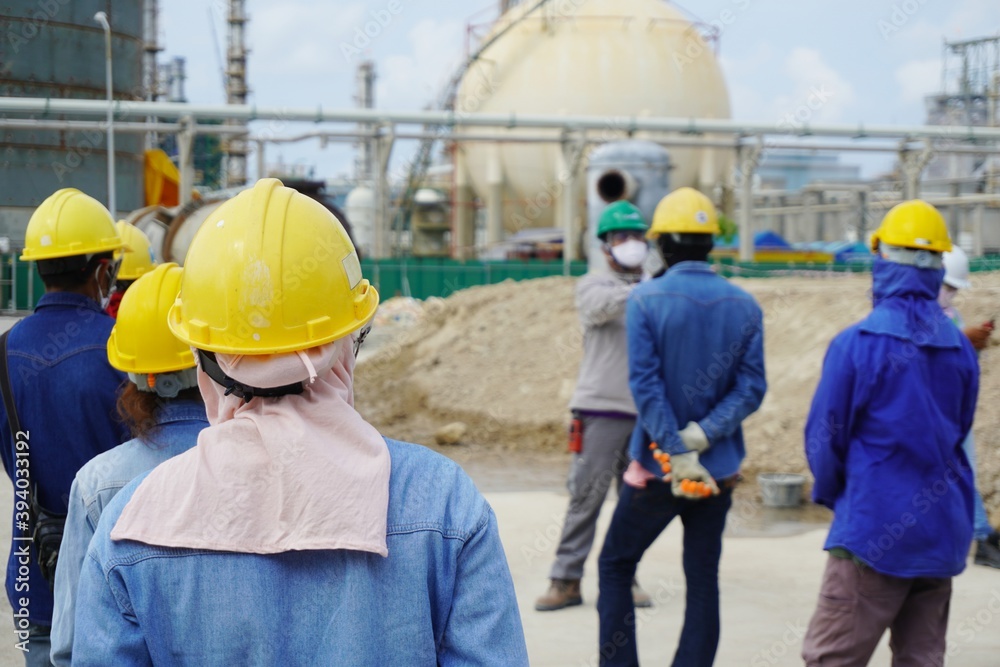 Wall mural (focus on the safety helmet) construction worker in a safety meeting on morning talk before work at 