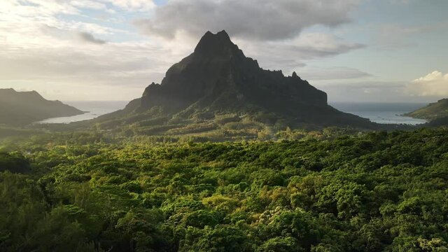 Drone aerial view: Mount Rotui, Moorea, Tahiti French Polynesia. Slow motion drone shot. Exotic travel vacation, paradise getaway, honeymoon destination.  