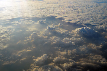 White fluffy clouds in the blue sky. Photos of clouds from the passenger liner porthole. 
