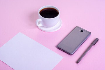 Fototapeta na wymiar Minimal office desk table with smartphone, cup of coffee, paper and pen on pink background.