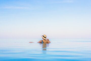 Portrait beautiful young asian woman relax smile leisure around outdoor swimming pool nearly sea