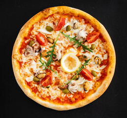 seafood pizza on the black background