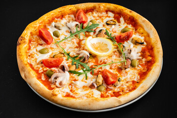 seafood pizza on the black background