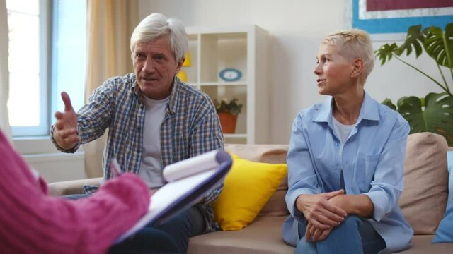 Senior husband talking to psychologist counselor complaining about bad relationship with wife