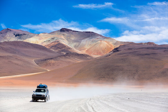 Off-road vehicle driving in the Atacama desert in Eduardo Avaroa Andean Fauna National Reserve, Bolivia