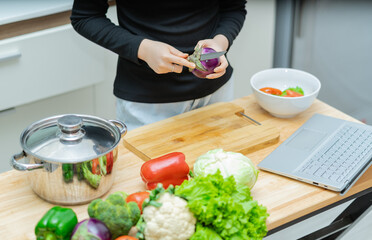 Woman is learning to cook by herself at home, online cooking course