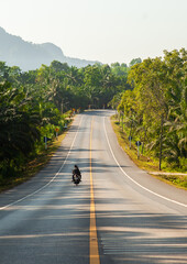 Motorcyclist on the road in Thailand.
