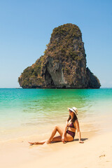 Woman in swimsuit and hat on the beach, Krabi, Thailand. - 394059114