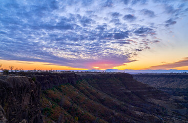 Sunset in California Mountains with orange skies and white and blue skies. Lookout Point Paradise California.   