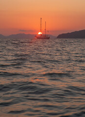 Sail boat and sunset. - 394059387
