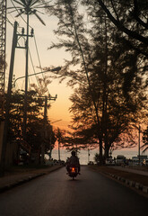 Motorcyclist on the road in Thailand. - 394059575