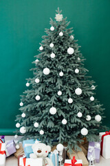 New Year's holiday Christmas tree decor with gifts and interior garlands