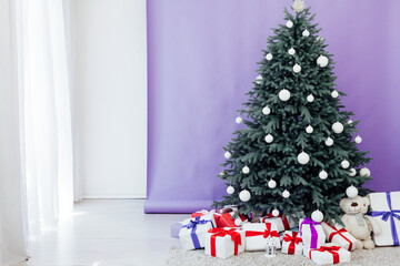 New Year's Christmas Tree with gifts and decor garlands interior