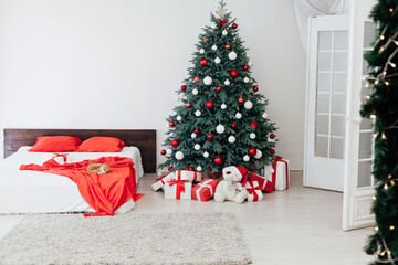 New year bedroom decor with Christmas tree bed with gifts and garlands interior