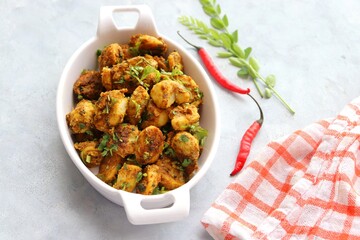 Stir fried taro roots. Arbi ki sabji, Taro roots masala curry. Arbi Masala. Garnished with...