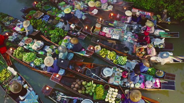 Damnoen Saduak Floating Market or Amphawa. Local people sell fruits, traditional food on boats in canal, Ratchaburi District, Thailand. Famous Asian tourist attraction destination. Festival in Asia.