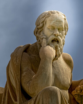 Socrates statue, the ancient Greek philosopher on sky background, enlighted by sunrays