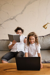 Dad Helps Preteenage Daughter With Homework Using Laptop. Stay at Home During Pandemic Lockdown. Hometask Time