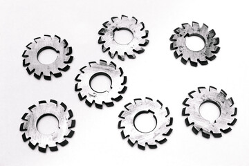 Several metal milling disc cutters for industrial equipment. The tool is isolated on a white background. Close-up