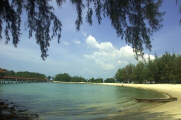 a calm and beautiful lagoon with wooden pedestrian bridge over it in Port Dickson beach Malaysia
