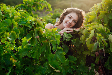 woman in green dress in the garden of grapes harvest