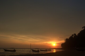 Fototapeta na wymiar fishing boat under sunset at Teluk Kemang beach in Port Dickson Malaysia 
